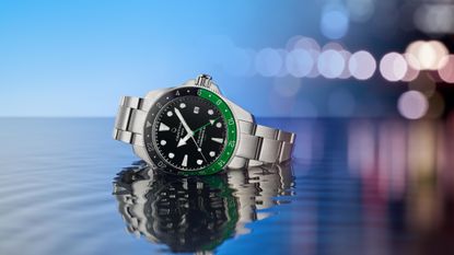 The Certina DS Action GMT Powermatic 80 in water with lights in the background
