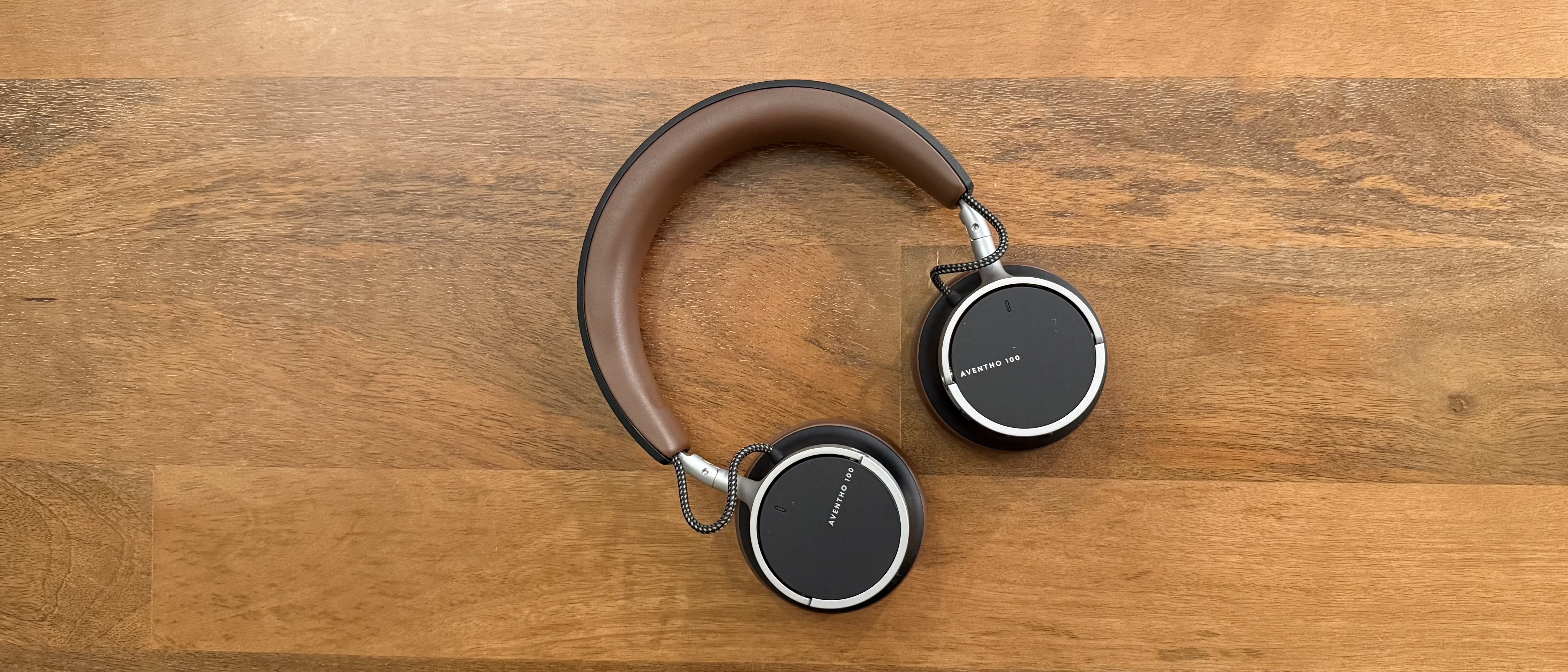Beyerdynamic Aventho 100 headphones on a wooden table 