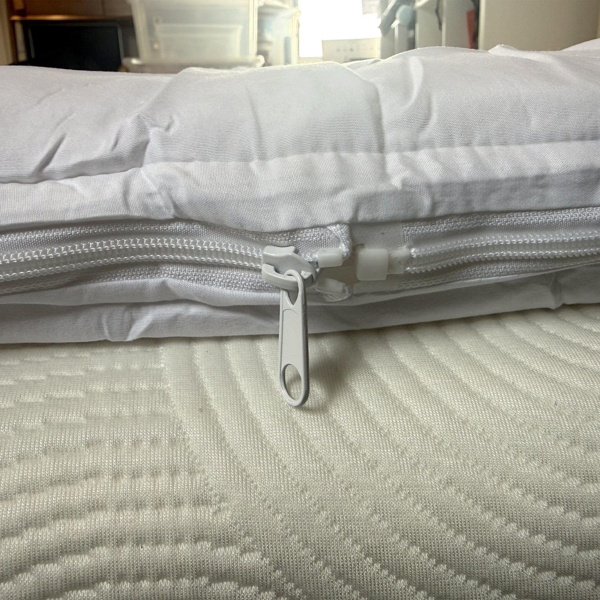 Next White Sleep In Comfort Dual Layer Mattress Topper being tested on a bed at home