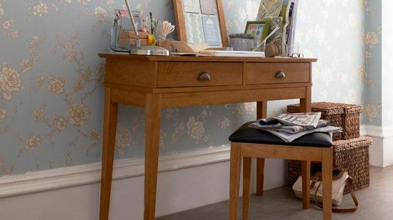 wallpaper on wall with desk and stool with handbag