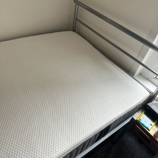 The Emma NextGen Premium mattress on a metal bed frame