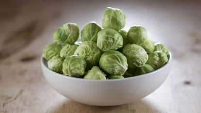 Bowl of harvested Brussels sprouts on a table