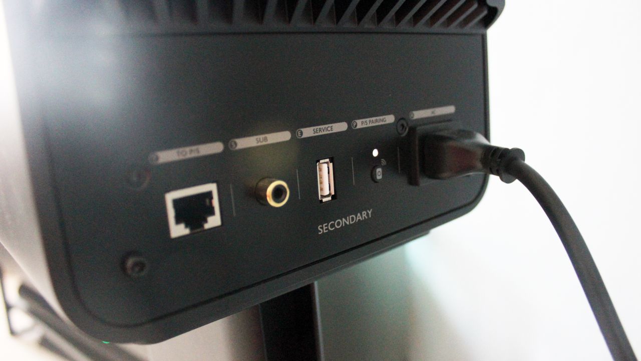 The connection ports of the Kef LS50 speakers, on the rear of one speaker unit. There are ethernet, subwoofer, USB and port connections, and a button to pair the two Kef speakers together