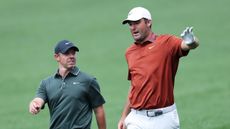 Rory McIlroy (left) and Scottie Scheffler chat during round one of the 2025 PGA Championship