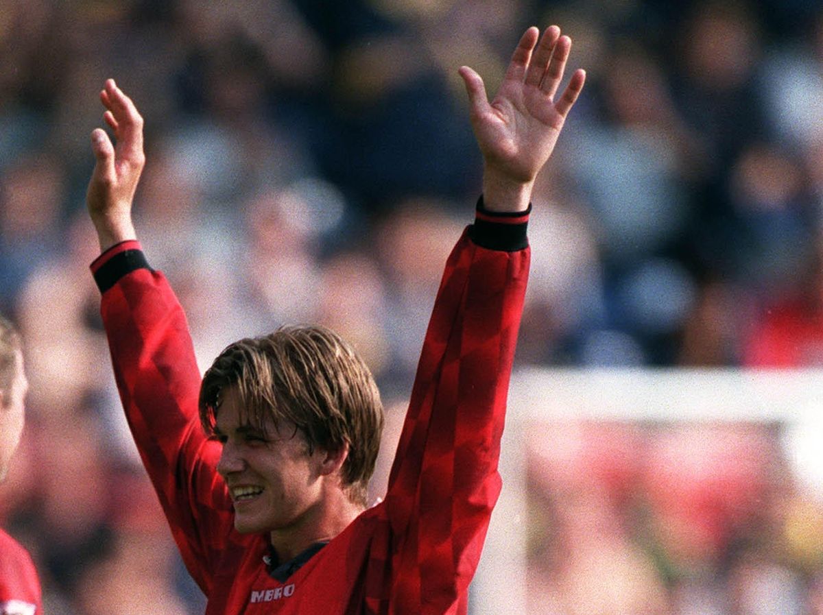 Manchester United&#039;s David Beckham celebrates after scoring his famous goal from the halfway line against Wimbledon, August 1996