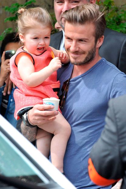 David Beckham carries Harper Beckham in London