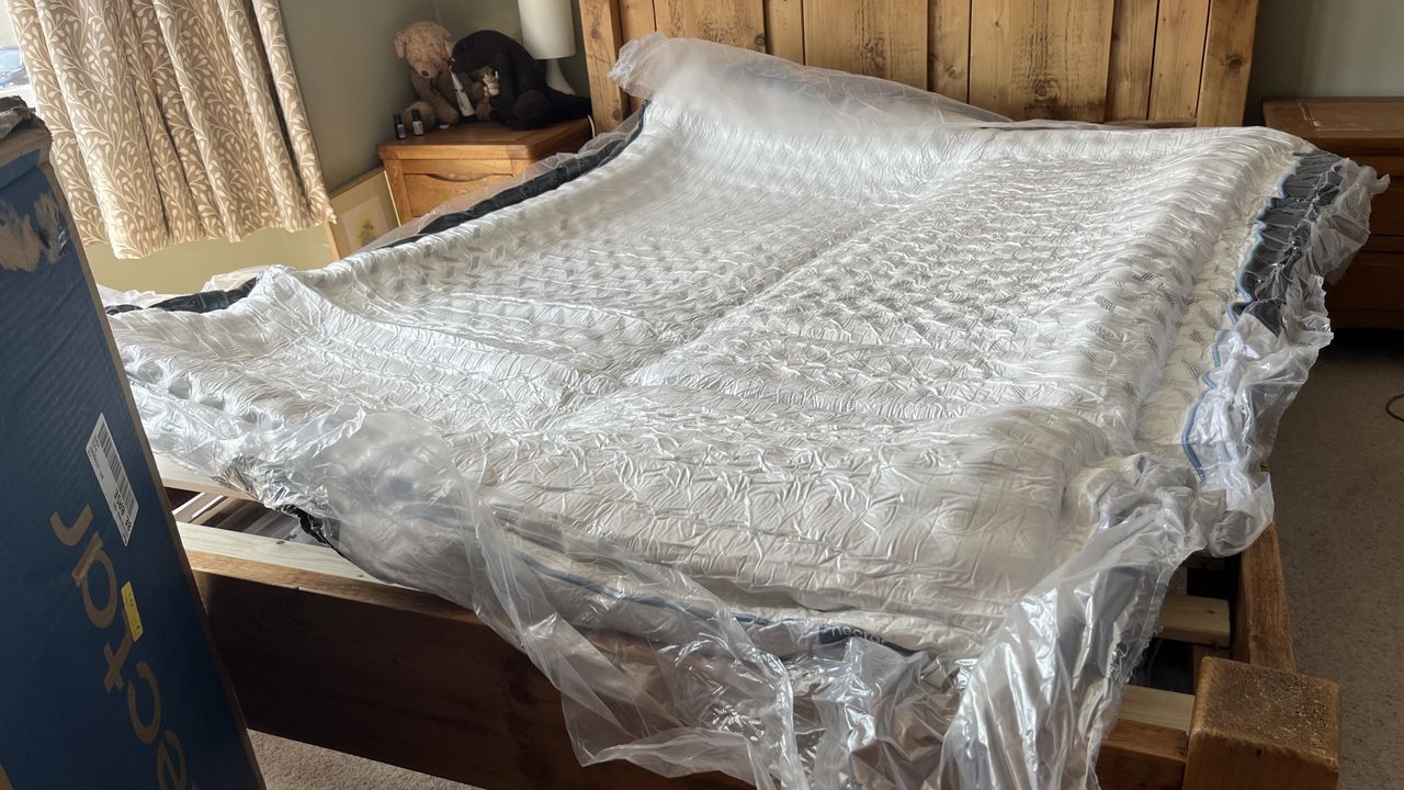 nectar classic hybrid mattress wrapped in plastic, full size on wooden bed frame