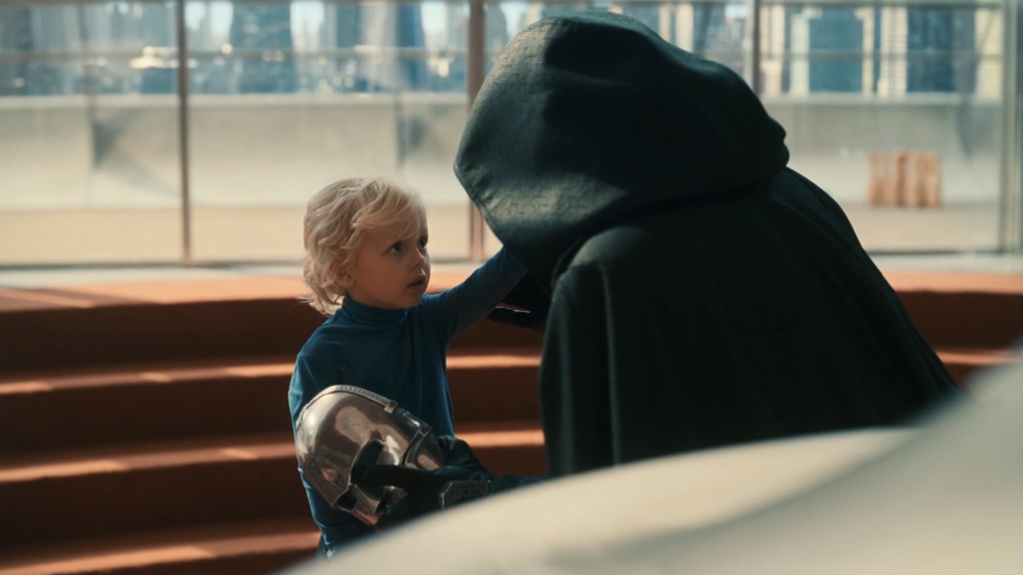 Franklin Richards touching the unmasked face of Doctor Doom in The Fantastic Four: First Steps