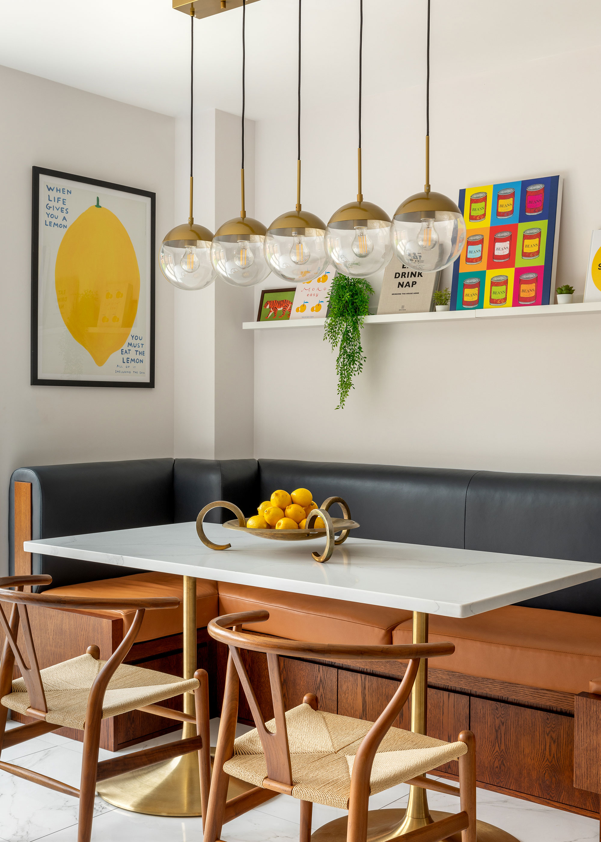 modern dining area with built-in banquette seating and lighting over dining table