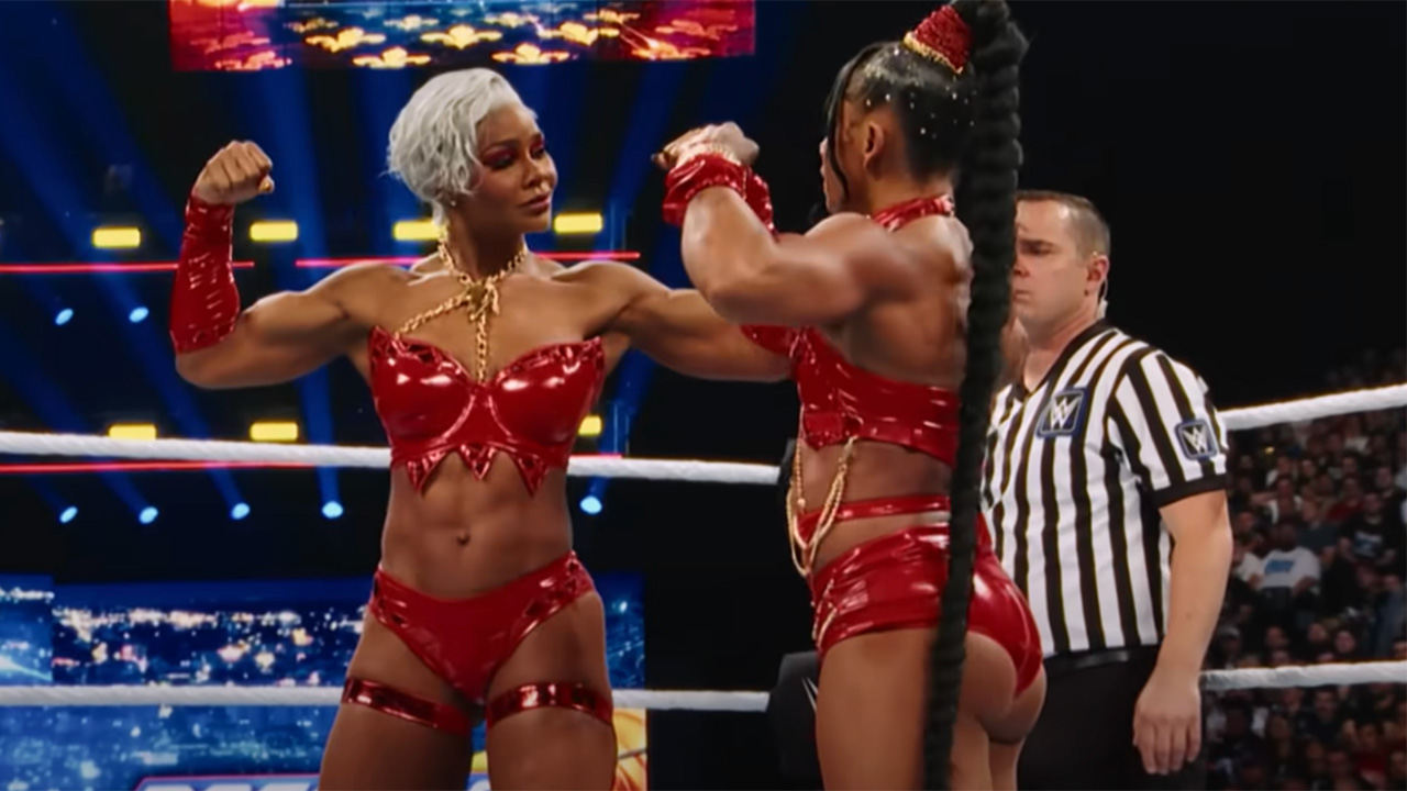 Netflix's Unreal showing off Bianca Belair and Jade Cargill's red outfits in the ring. Bianca's braid falls past her butt.