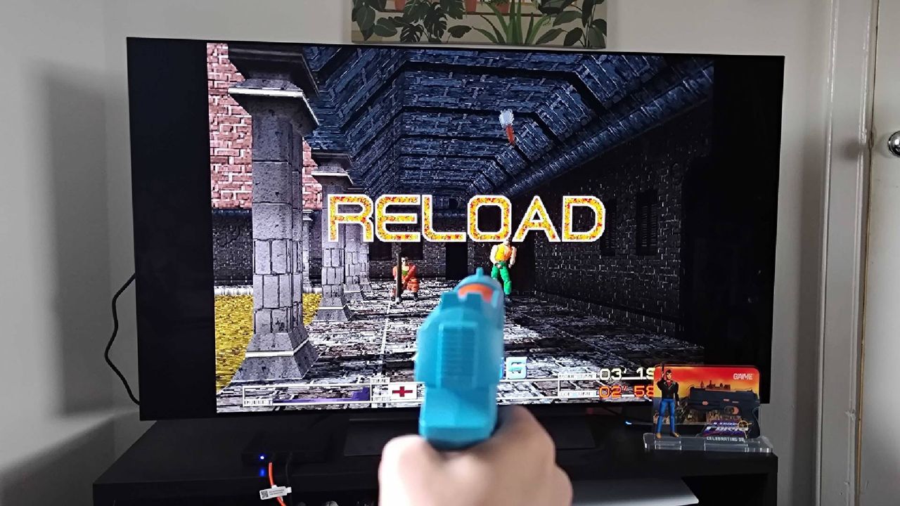 G'AIM'E Time Crisis Lightgun gameplay with words "reload" on screen.