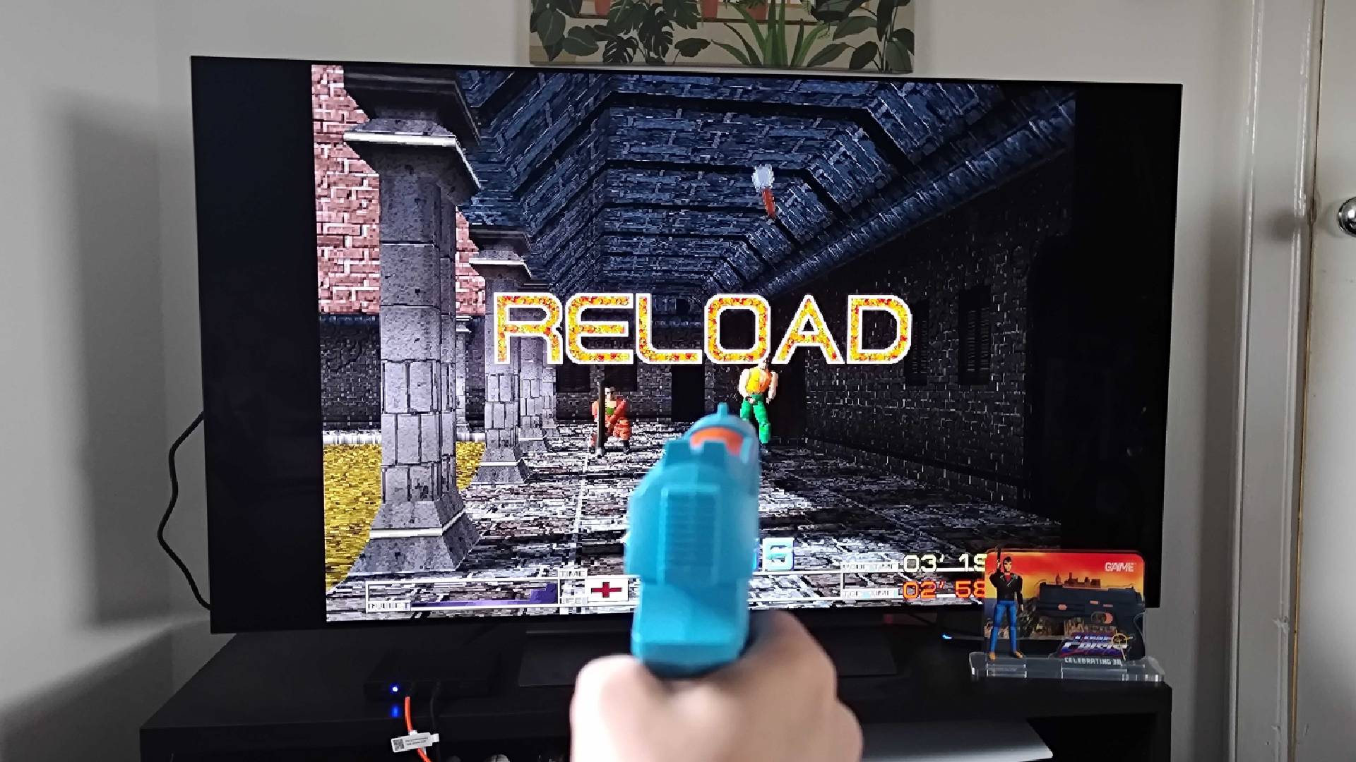 G'AIM'E Time Crisis Lightgun gameplay with words "reload" on screen.