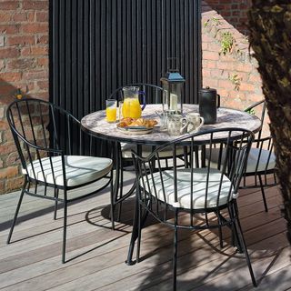 garden table with metal chair on wooden flooring