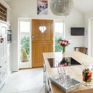 kitchen with white wall and wooden door