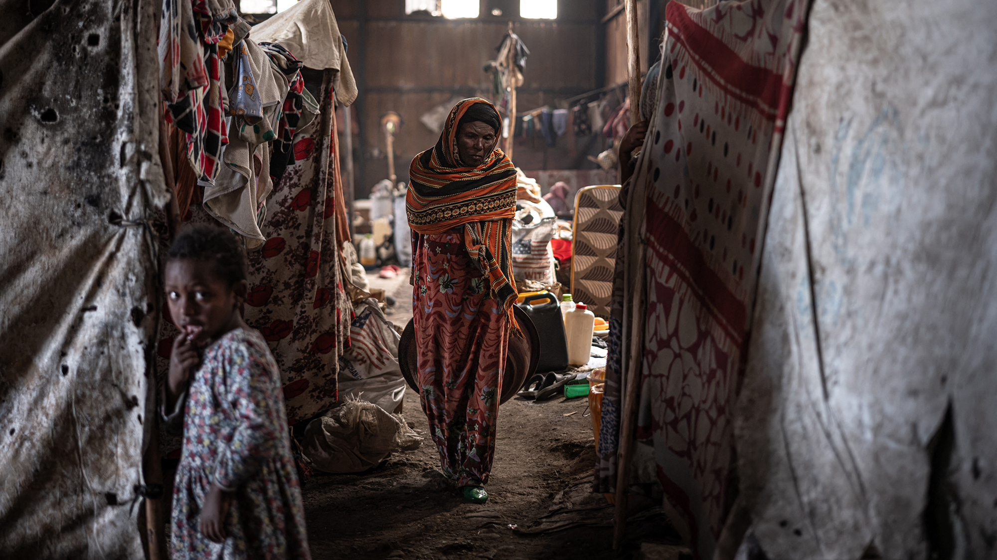 A displaced Amhara woman is seen at a warehouse shared by dozens of families as insecurity in Ethiopia's Oromia region continues to hinder their return home, at the China Paper Factory camp for internally displaced people in Debre Berhan, Ethiopia