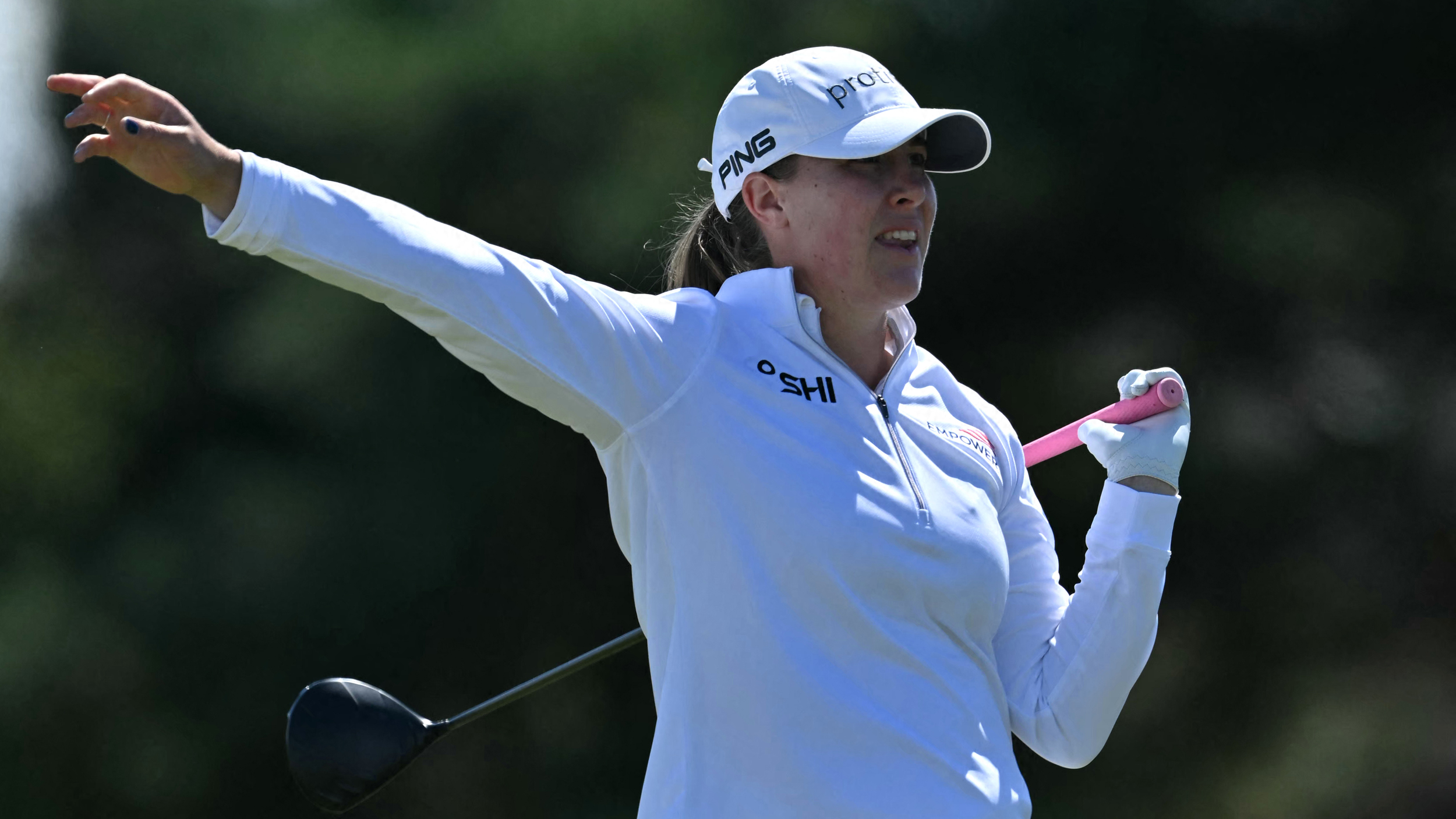 Jennifer Kupcho holds her arm out to indicate a stray drive at the AIG Women's Open