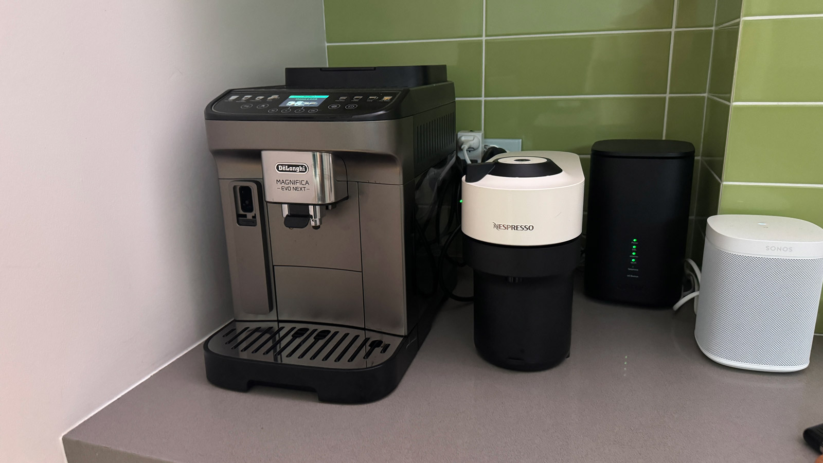 De'Longhi Magnifica Evo Next coffee machine on a kitchen counter, next to a Nespresso Vertuo Pop.