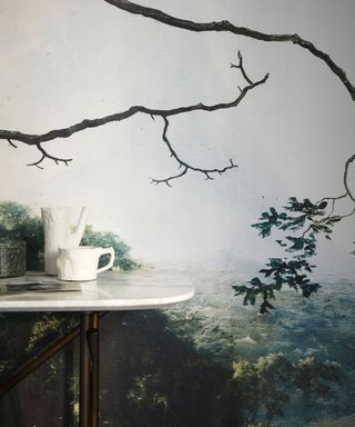 Close up of natural landscape wall mural, console table with ornaments
