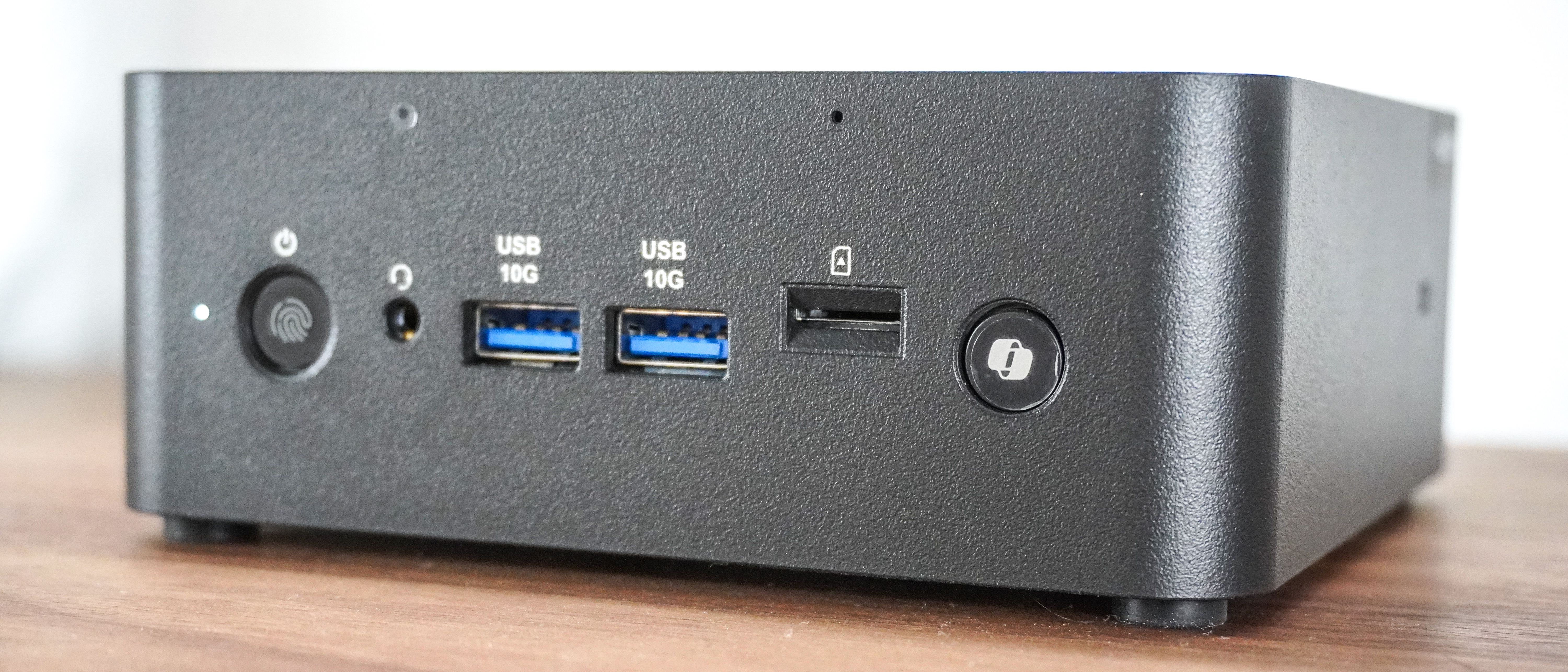 An angled shot showing off the front ports and buttons of the MSI Cubi NUC AI+ 2MG
