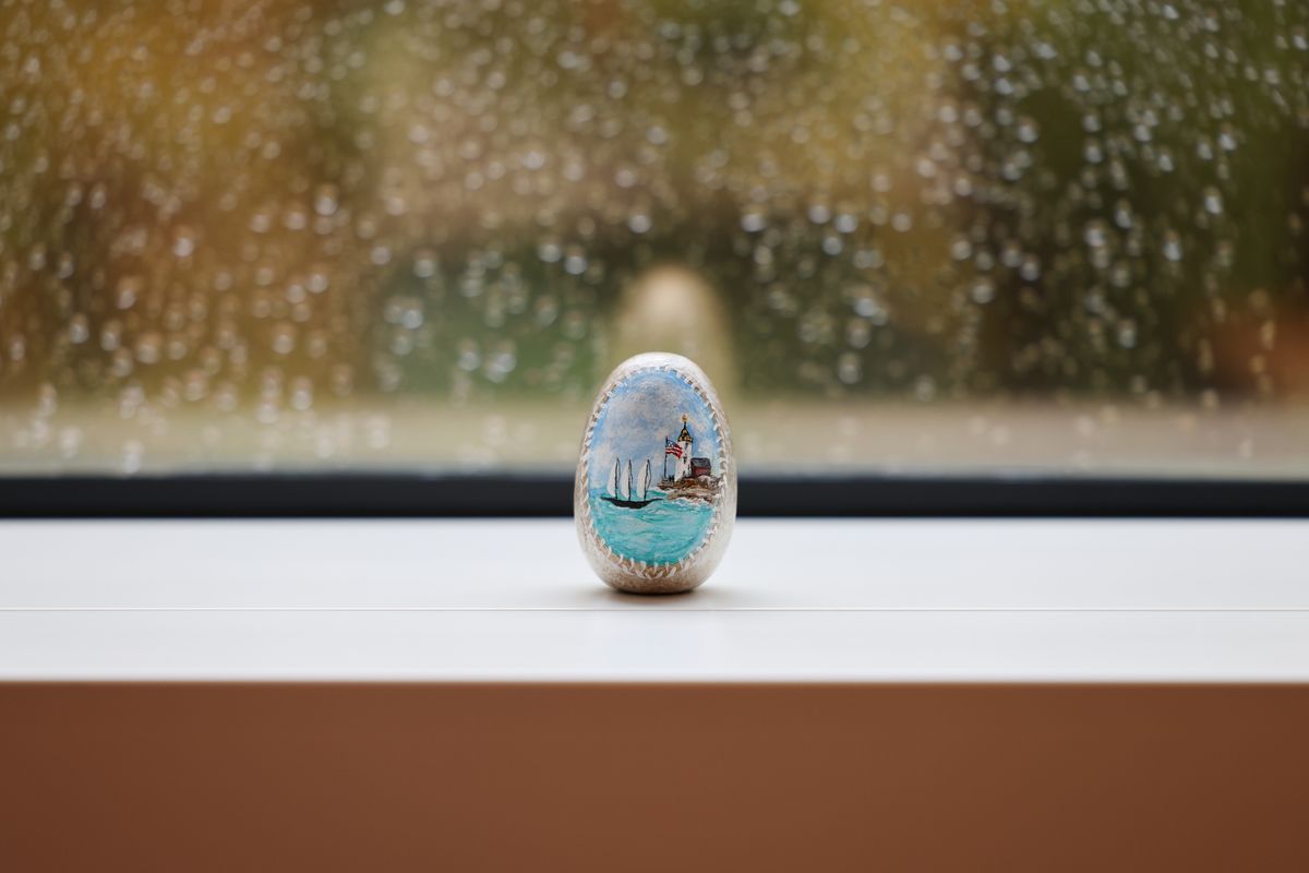 Painted stone in front of a window