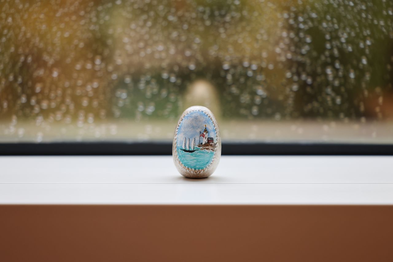 Painted stone in front of a window