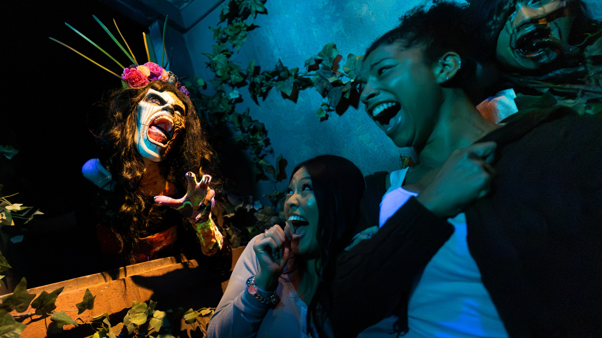 A scareactor in the KILLcea&amp;ntilde;era house reaching out to scare guests at Halloween Horror Nights 2026 at Universal Studios Hollywood.