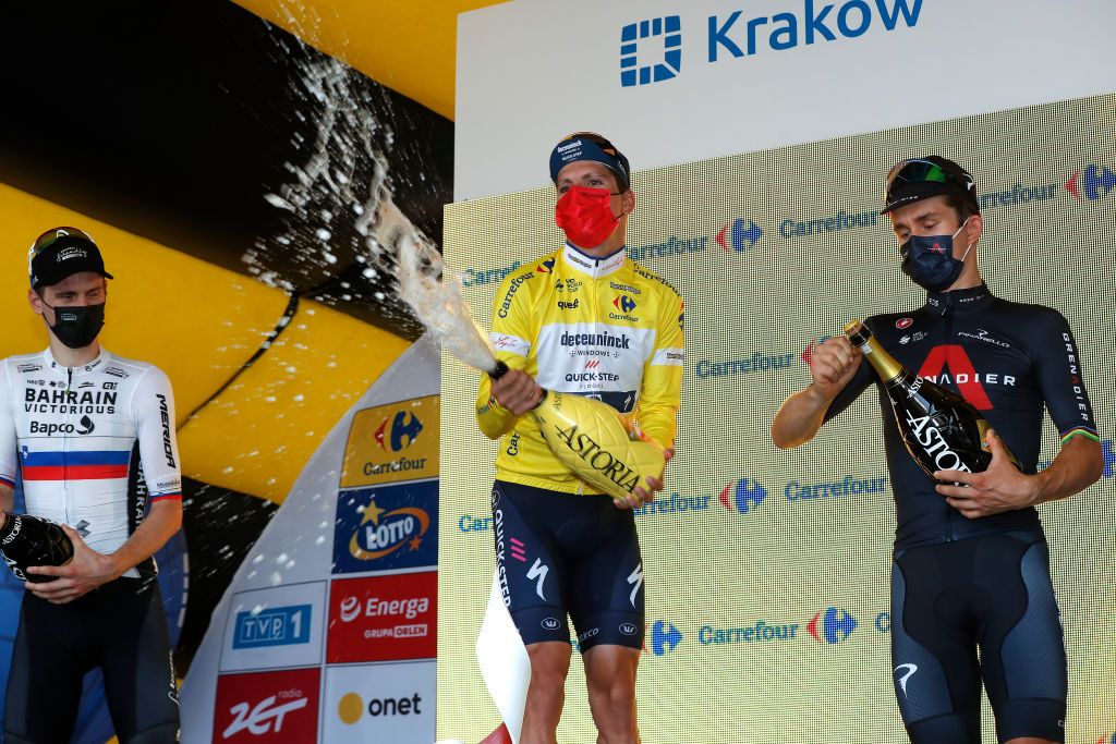 KRAKOW POLAND AUGUST 15 LR Matej Mohoric of Slovenia and Team Bahrain Victorious on second place race winner Joo Pedro Gonalves Almeida of Portugal and Team Deceuninck QuickStep Yellow Leader Jersey and Michal Kwiatkowski of Poland and Team INEOS Grenadiers on third place pose on the podium during the podium ceremony after the 78th Tour de Pologne 2021 Stage 7 a 145km stage from Zabrze to Krakw TourdePologne TDP2021 UCIWT on August 15 2021 in Krakow Poland Photo by Bas CzerwinskiGetty Images