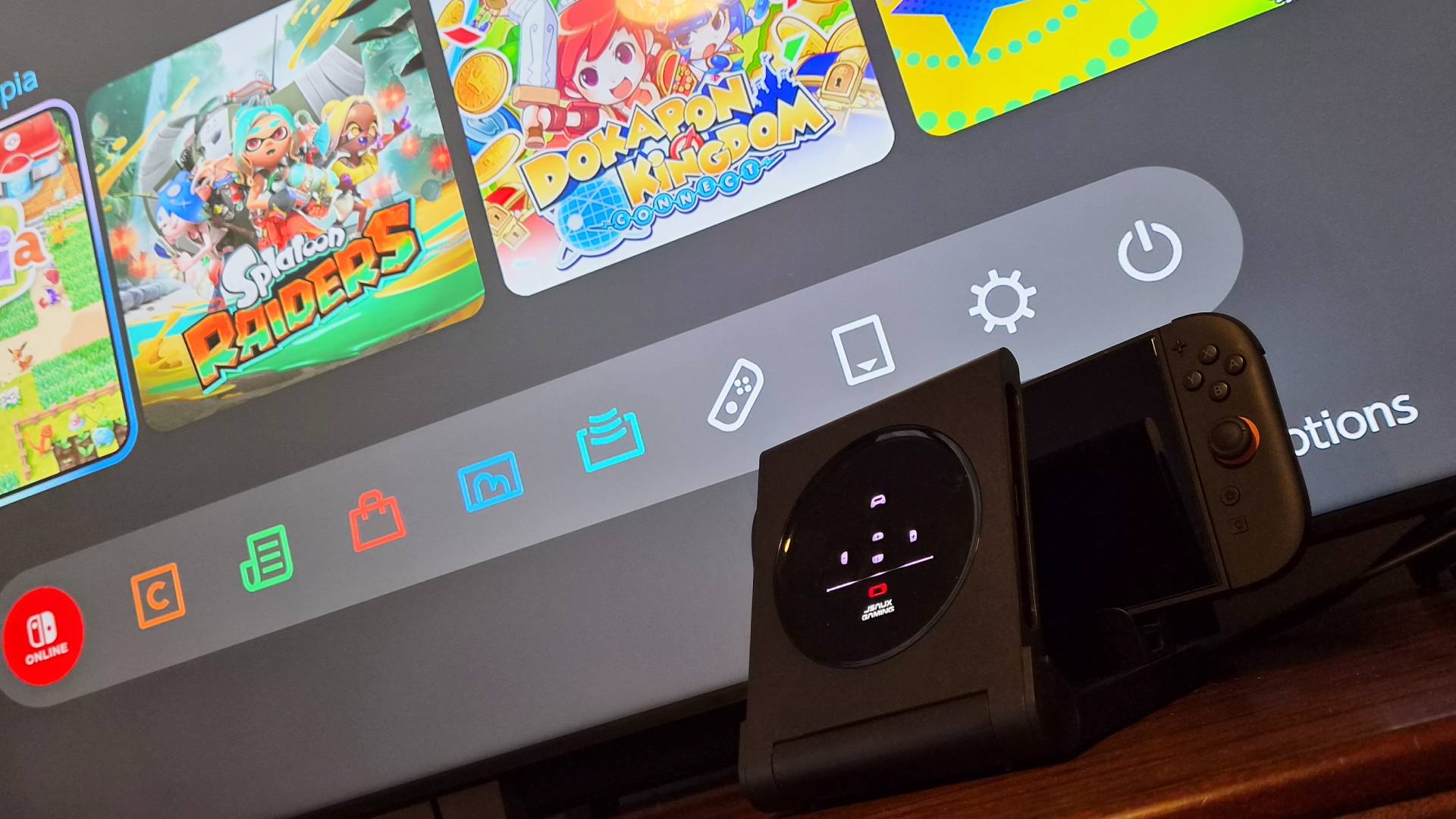 Photo of the JSAUX 6-in-1 Gaming Dock for the Switch 2 sitting in front of a TV.