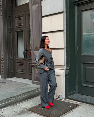 @mimixn walking wearing a baggy grey sweater with grey trousers and red heels