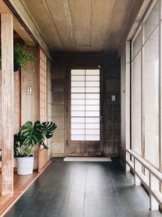 Minimalist interior entryway with dark wood floors