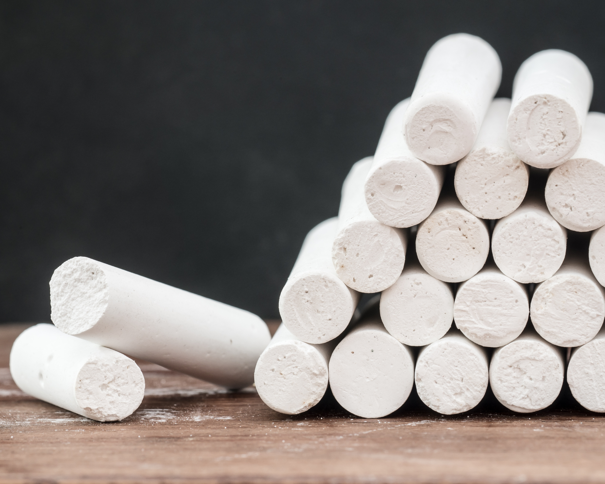 Sticks of white chalk on wood table