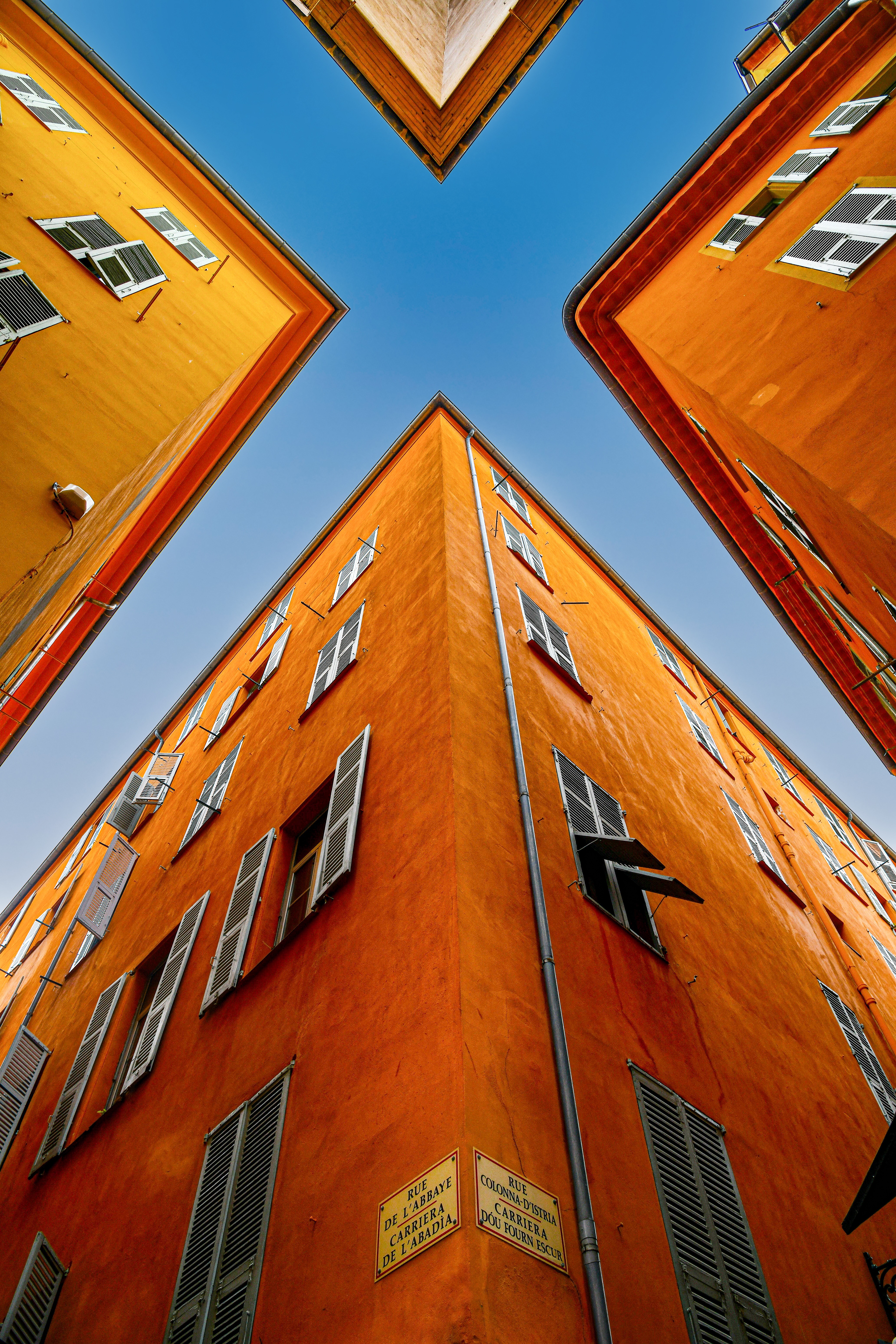 Ochre-coloured buildings with blue shutters