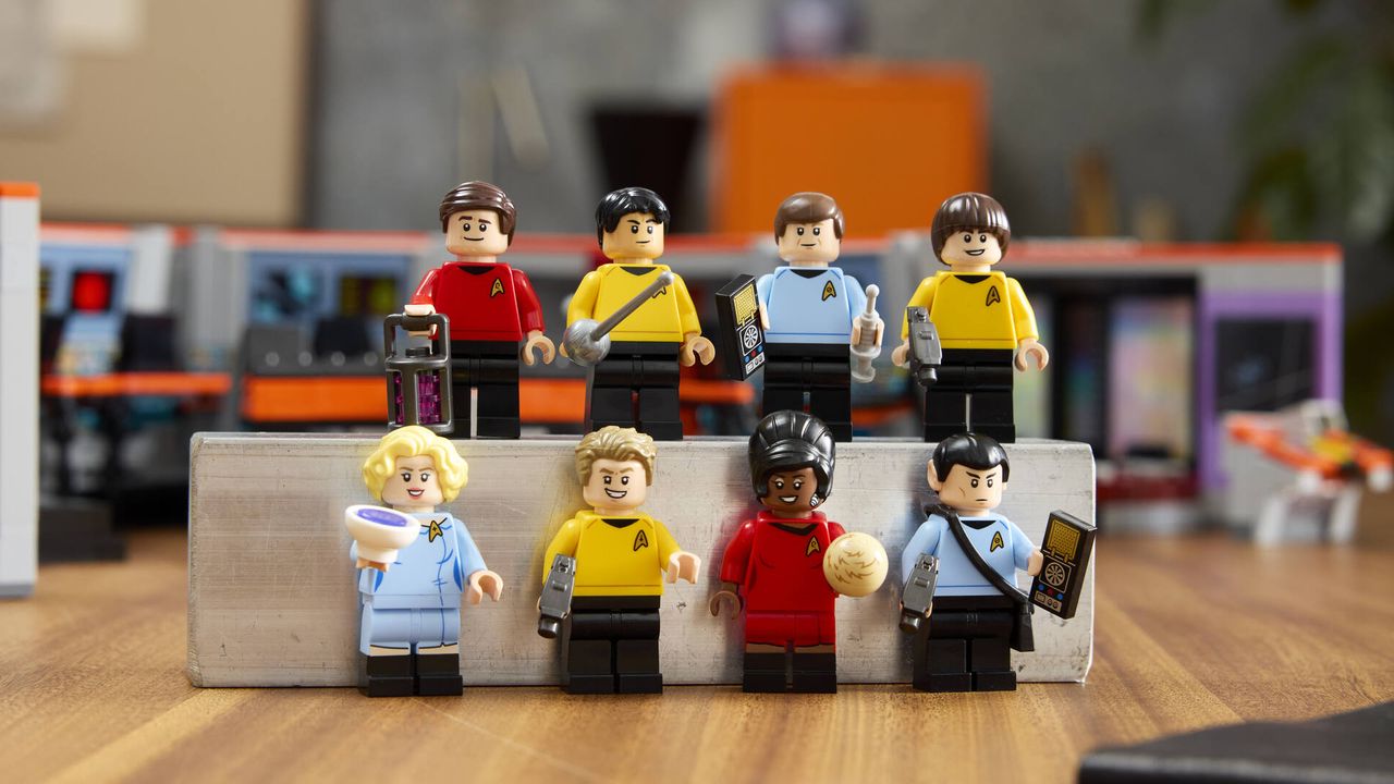 Lego Star Trek Enterprise Bridge minifigures laid out on a wooden surface