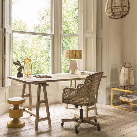 tranquil home office desk in front of window with chair