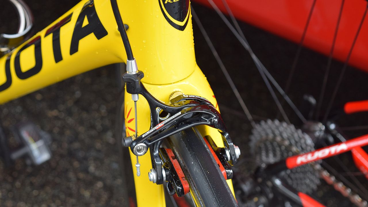 Carbon rim specific brake pads double up as colour coordinated accessories for the red and yellow custom frameset