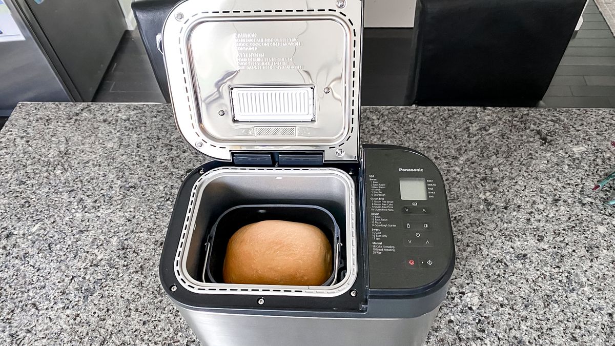 Panasonic Automatic Bread Maker on a kitchen counter with a finished loaf inside the machine
