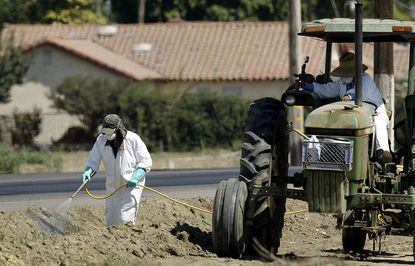 Farmers spray pesticides in California.