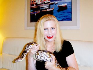 Taryn Hook with Larry, a beloved boa constrictor whose affliction prompted the lifelong keeper of reptiles to get in touch with a researcher who hunts down viruses.