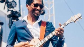 Guitar Ron Artis II performs onstage