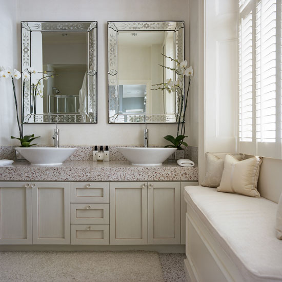 White bathroom with two mirrors and basins