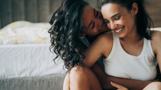 lesbian couple hugging and smiling