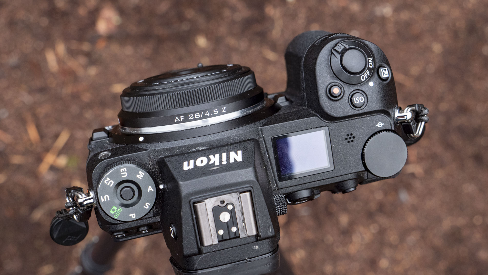 Viltrox AF 28mm f/4.5 body cap lens mounted to a Nikon mirrorless camera, outdoors in open nature