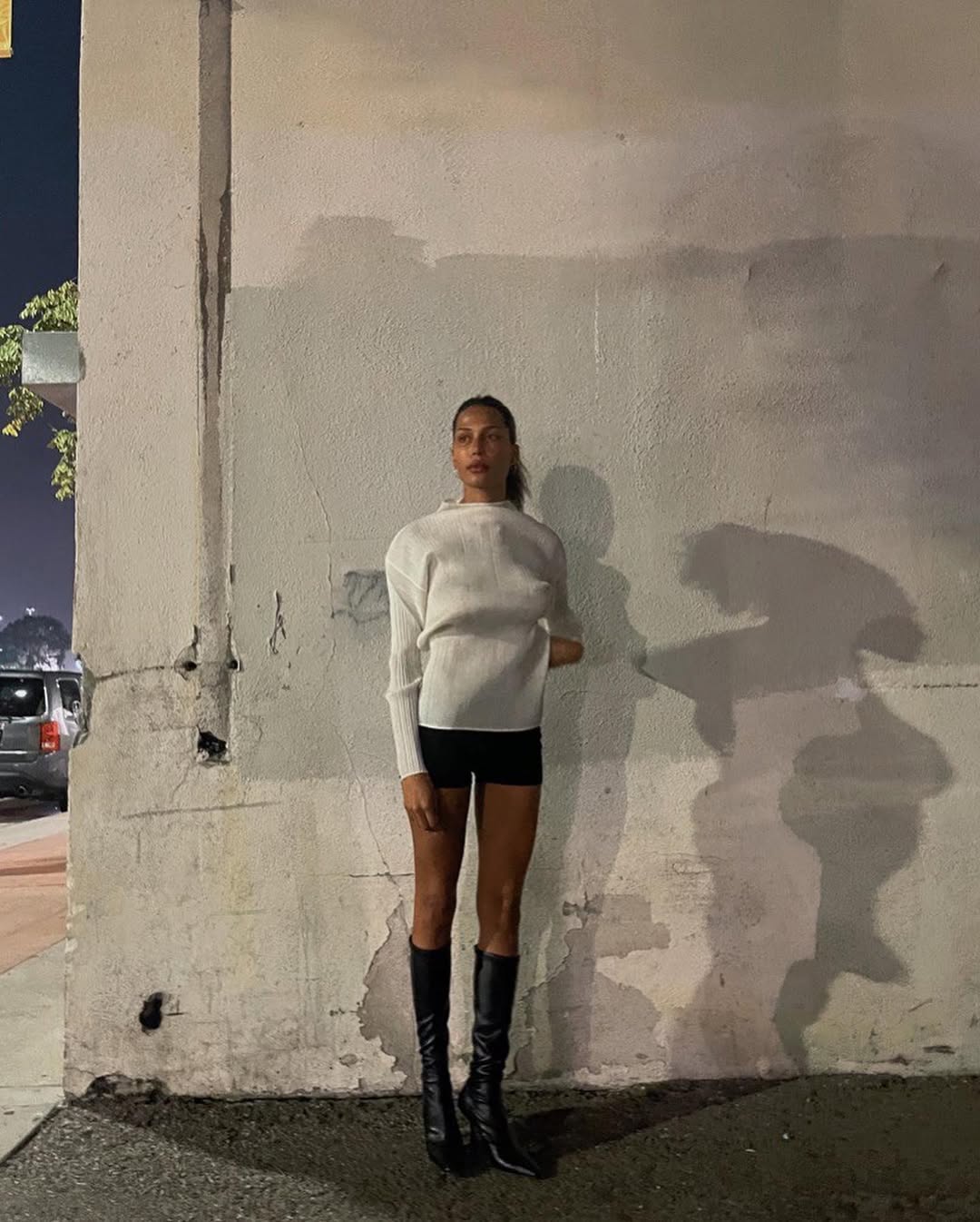 woman wearing knee high fitted boots