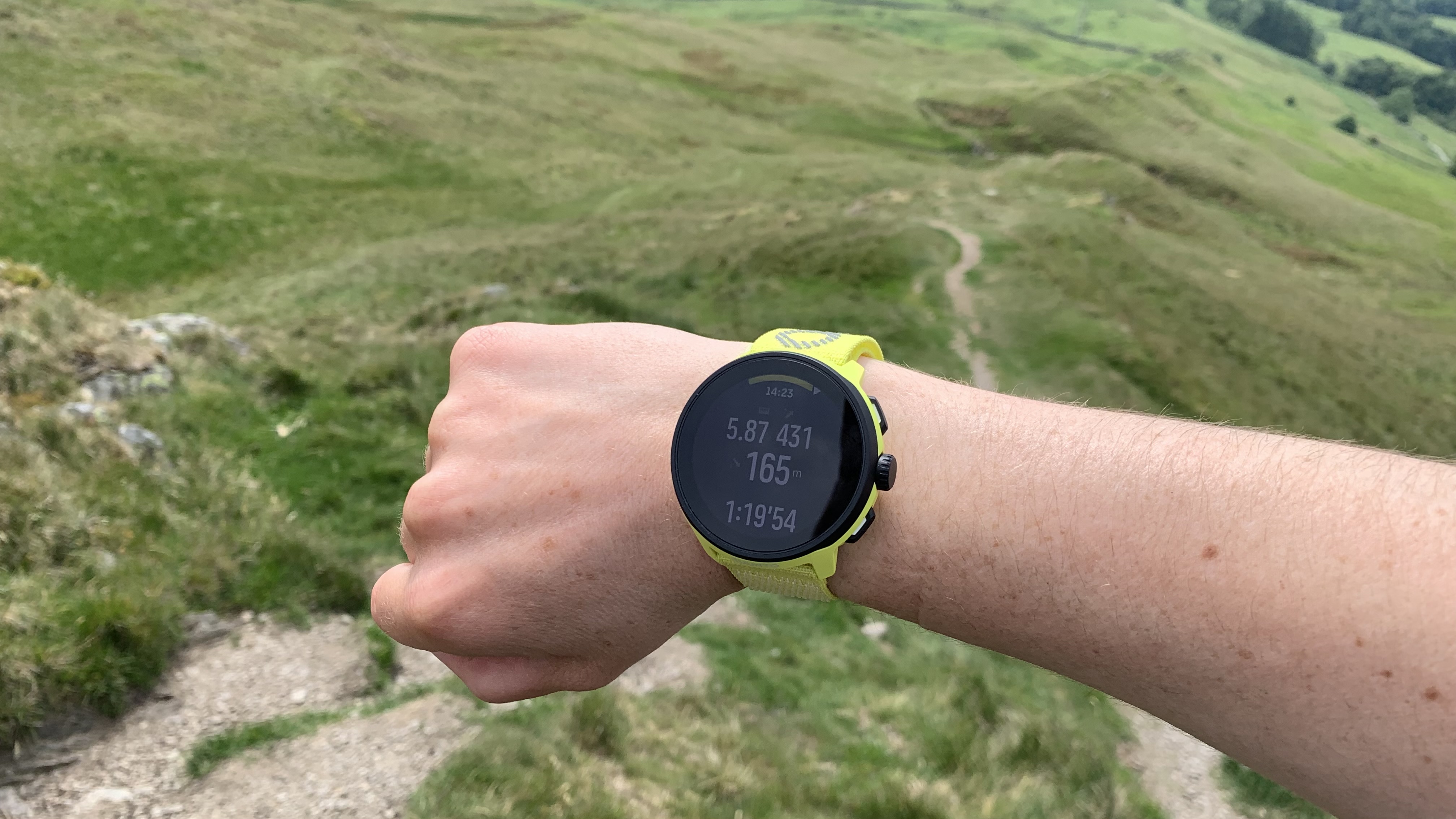 A runner's wrist wearing the Suunto Run watch in the Lake District