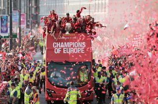 Liverpool players celebrate their Champions League final win over Tottenham on a bus parade through the city in 2019.