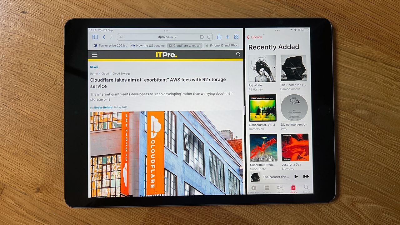 A photograph of the 12.9in 2021 Apple iPad Pro resting on a wooden surface