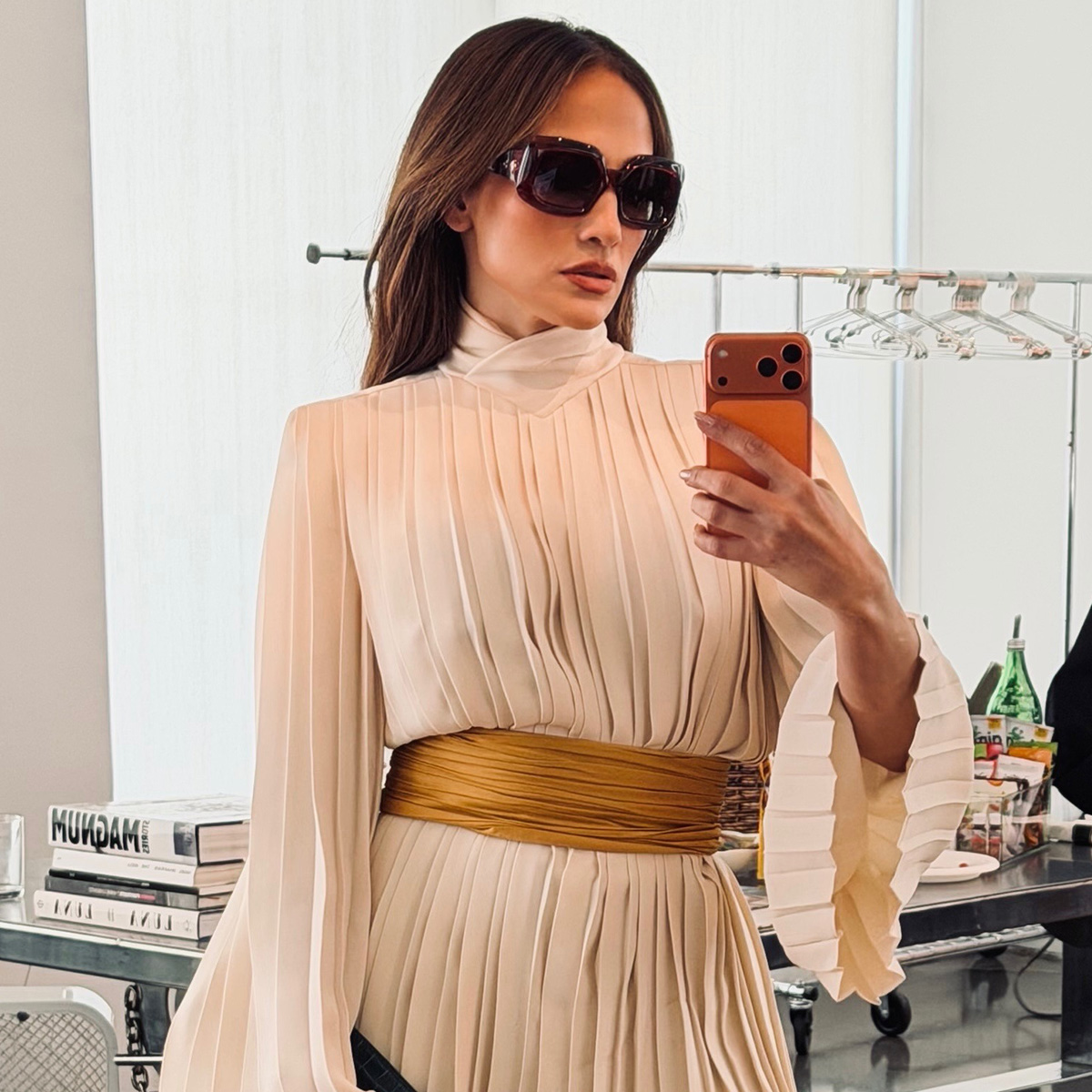 jennifer lopez wears a ruched minidress with sunglasses.