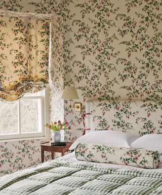 Bedroom with Fuschia wallpaper and blind by Colefax & Fowler