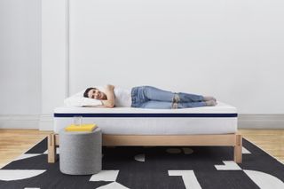 A woman lying on a Helix Midnight mattress