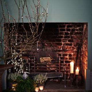 room with grey wall and fireplace and candles